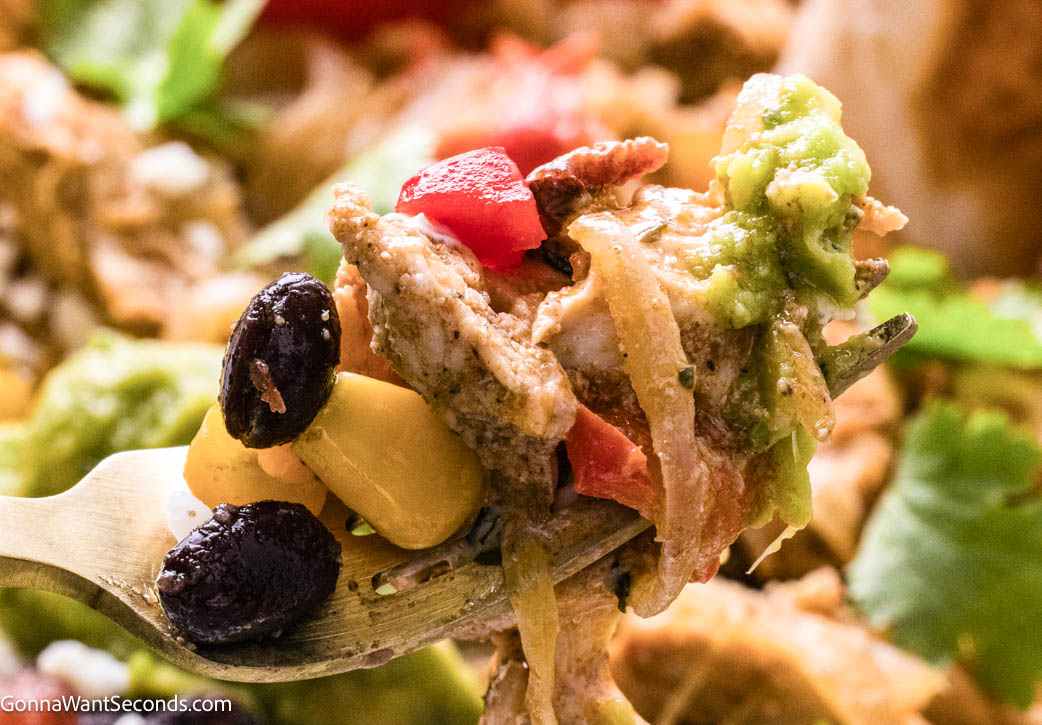Chicken Fajita Bowls loaded with lime-marinated chicken, sautéed peppers, rice, crisp greens, and creamy chipotle dressing. Easy, fresh, flavorful! #chickenfajitabowls #chickenfajita forkful of Chicken Fajita Bowls