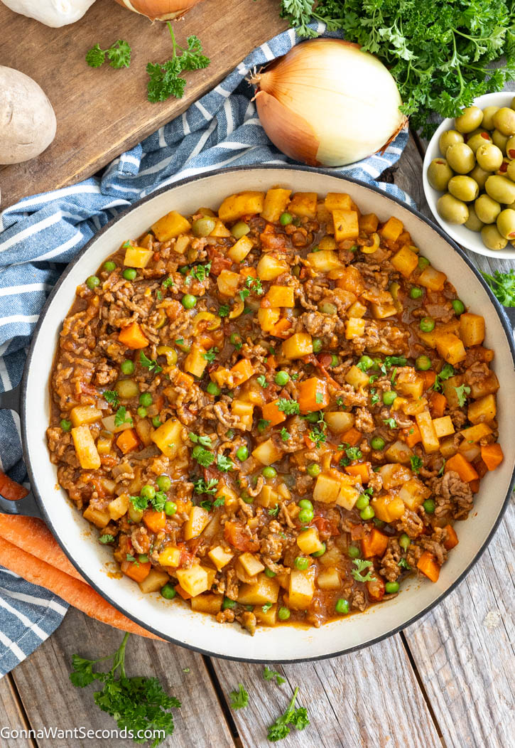 Mexican Picadillo is a cozy, hearty skillet meal with ground beef, potatoes, carrots, and tomatoes. It's simple, affordable, and perfect for busy family dinners. #mexicanfood #picadillo Mexican Picadillo in a skillet top shot