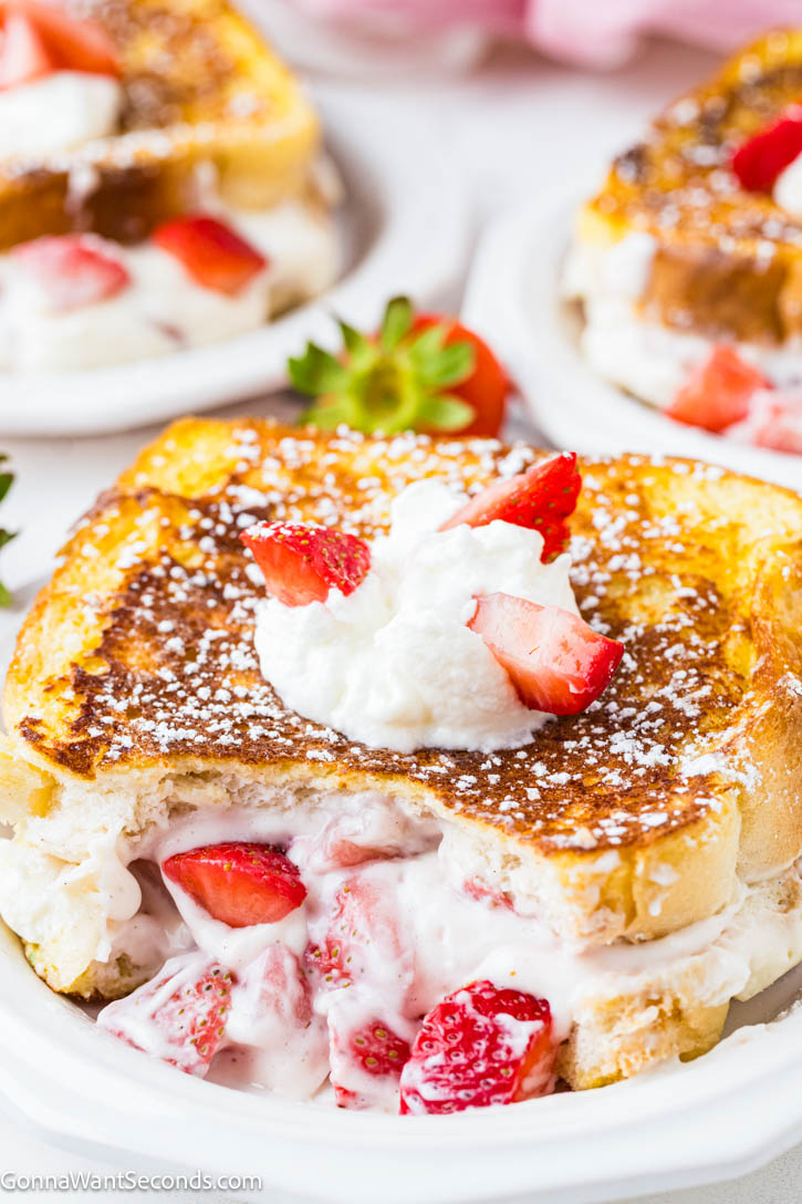 Strawberry Stuffed French Toast feels indulgent yet easy, with brioche filled with cream cheese and fresh strawberries, dipped in cinnamon-vanilla custard. #frenchtoast #strawberrystuffedfrenchtoast Strawberry Stuffed French Toast on a plate