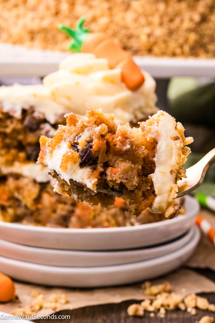 Ultra moist carrot cake with cream cheese frosting and a rich buttermilk glaze. Soft, bakery-style texture and perfectly spiced flavor. #carrotcake #creamcheesefrosting a forkful of carrot cake