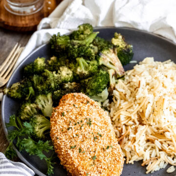 shake and bake pork chops with rice pilaf and roasted broccoli on a plate
