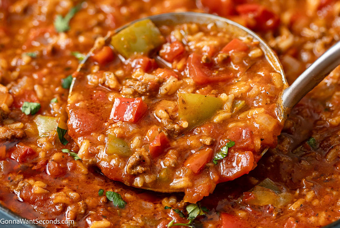 This stuffed pepper soup is rich, cozy, and packed with beef, peppers, and tomato flavor for an easy one-pot dinner with great leftovers. #stuffedpepper #groundbeefsoup ladle scooping stuffed pepper soup