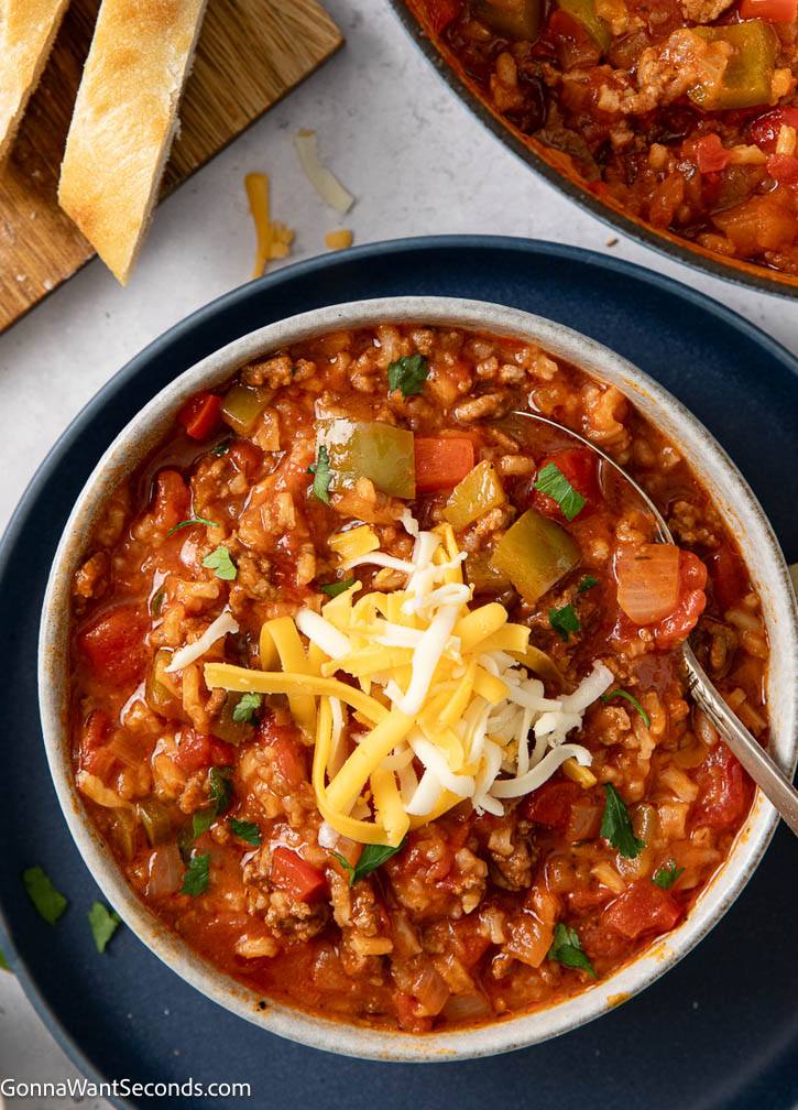 This stuffed pepper soup is rich, cozy, and packed with beef, peppers, and tomato flavor for an easy one-pot dinner with great leftovers. #stuffedpepper #groundbeefsoup stuffed pepper soup topped with shredded cheese