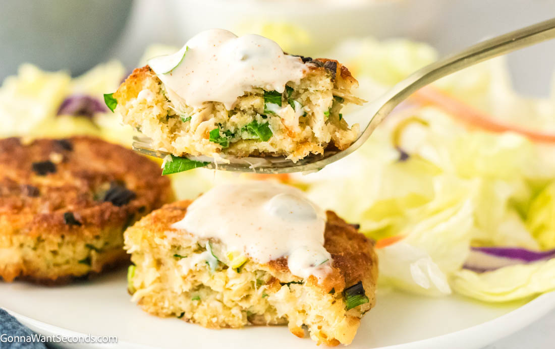 These crispy tuna cakes are easy, never mushy, and won’t fall apart. Made with simple ingredients, they’re perfect for a quick weeknight dinner. #tunacakes #tunapatties a fork with a piece of tuna cake and lemon caper sauce on top