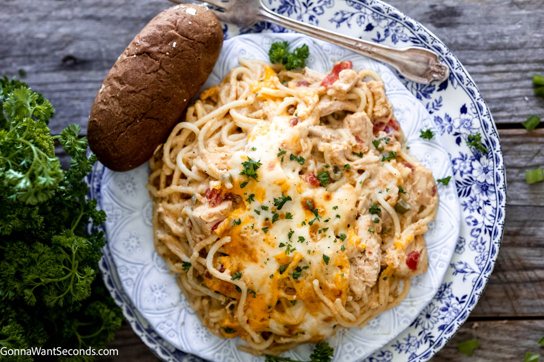 Best Creamy Chicken Spaghetti with bread on the side on a plate