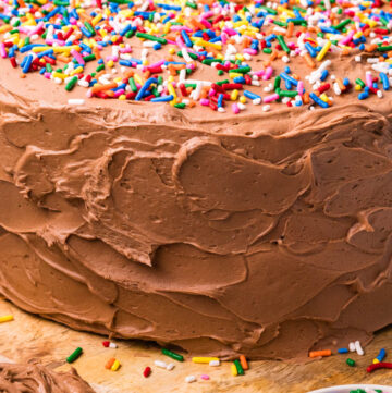 yellow cake with chocolate frosting with sprinkles on top