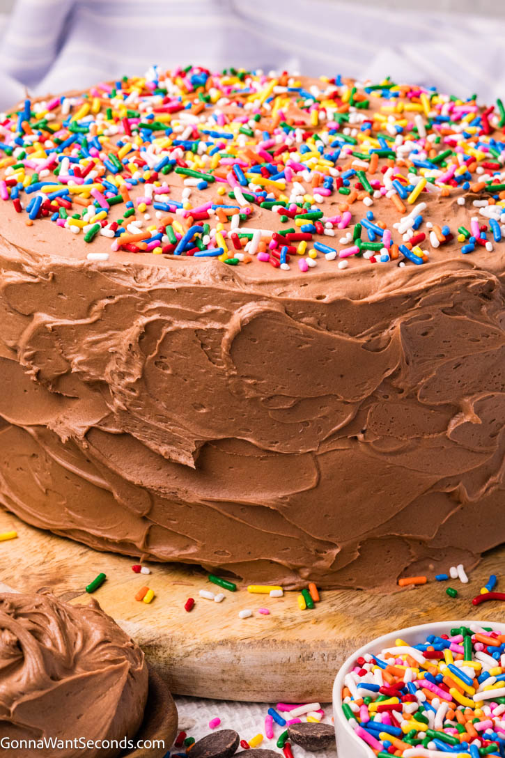 This Yellow Cake with Chocolate Frosting is soft, buttery, and incredibly moist with a fine, bakery-style crumb. #yellowcake #layeredcake yellow cake with chocolate frosting with sprinkles on top