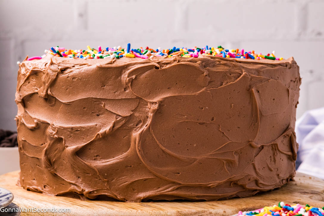 yellow cake with chocolate frosting with sprinkles on top