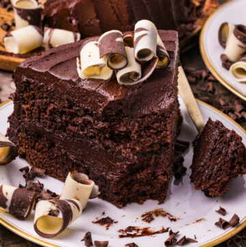 a slice of best chocolate cake topped with chocolate swirls