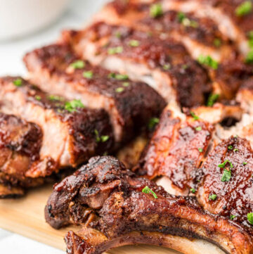 sliced crockpot ribs on a wooden board