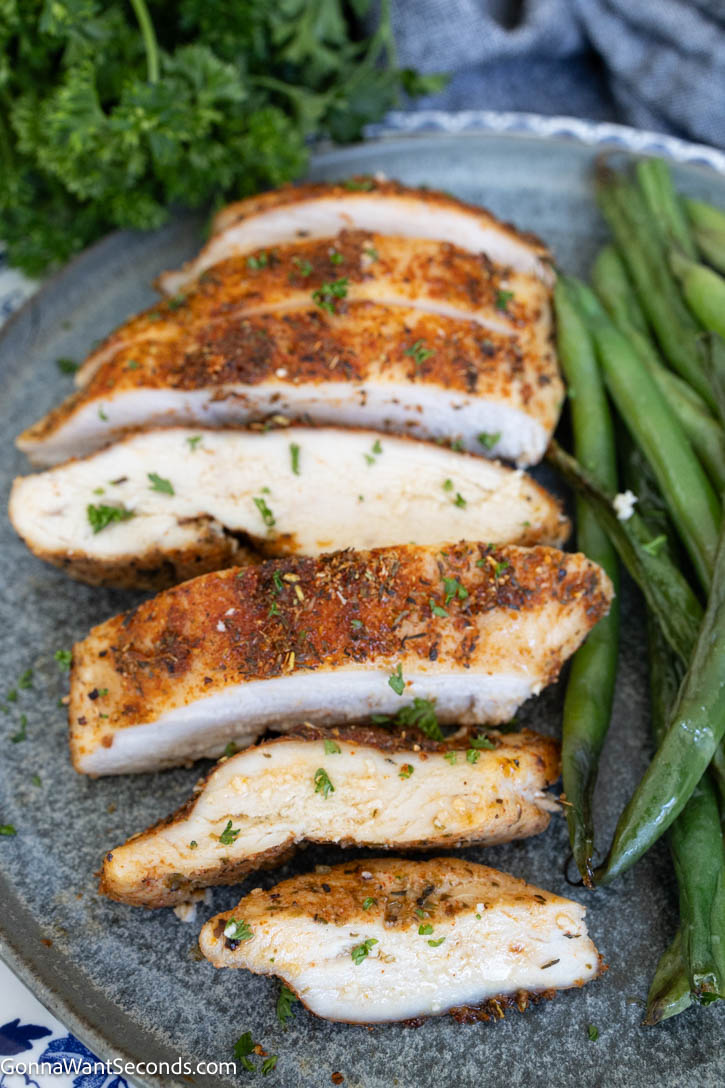 Learn how to make baked boneless chicken breast that’s juicy, tender, and never dry. This easy 425°F method works every time—perfect for weeknight dinners. #chickenbreast #bakedchickenbreast sliced baked boneless chicken breast with vegetables on the side