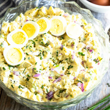 Deviled egg potato salad with sliced eggs on top in a bowl