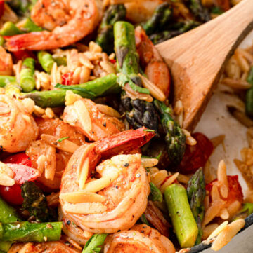 wooden spoon scooping shrimp orzo recipe
