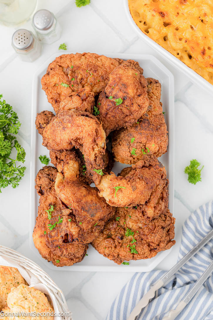 Make the best Fried Chicken Recipe with a crispy, golden crust and juicy, tender chicken. This easy buttermilk fried chicken is perfect every time! #friedchicken #buttermilkfriedchicken Fried Chicken Recipe on a platter