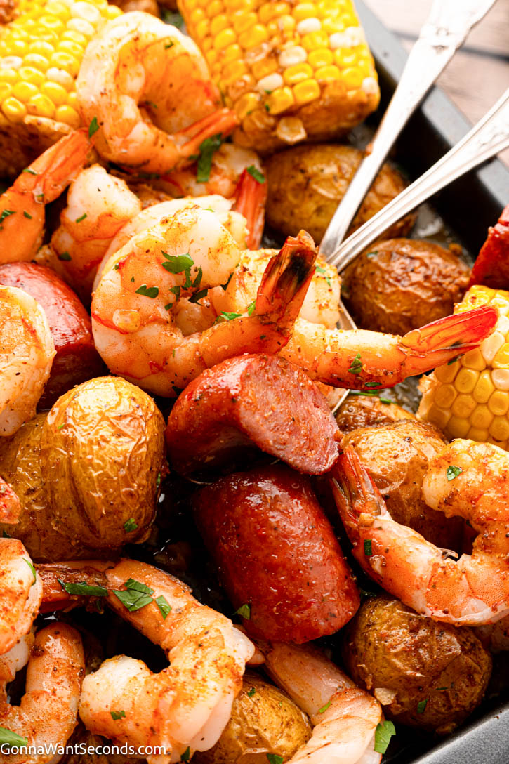 This Sheet Pan Shrimp Boil Recipe is loaded with juicy shrimp, smoky sausage, corn, and potatoes roasted in seasoned garlic butter for an easy one-pan dinner. #shrimpboil #sheetpanrecipes Sheet Pan Shrimp Boil close up