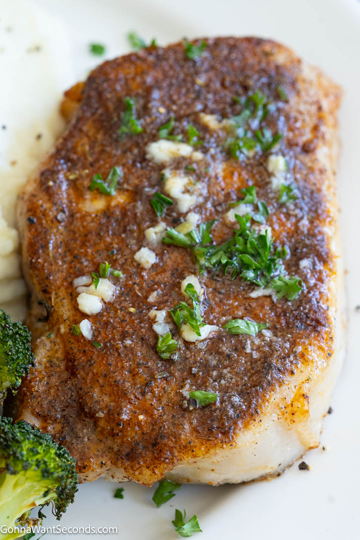 These juicy Baked Pork Chops are seasoned with pantry spices, baked to perfection, and finished with rich garlic butter. An easy 30-minute dinner the whole family will love. #bakedporkchops #porkchops Baked Pork Chops with rich garlic butter on top