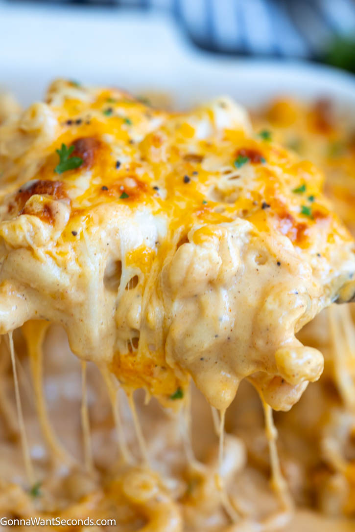 Tini’s Mac and Cheese is ultra creamy, cheesy, and packed with flavor. This viral mac and cheese recipe bakes up rich with the perfect cheese pull. #tinismacandcheese #macncheese Scooping Tini’s Mac and Cheese with dripping cheese strings