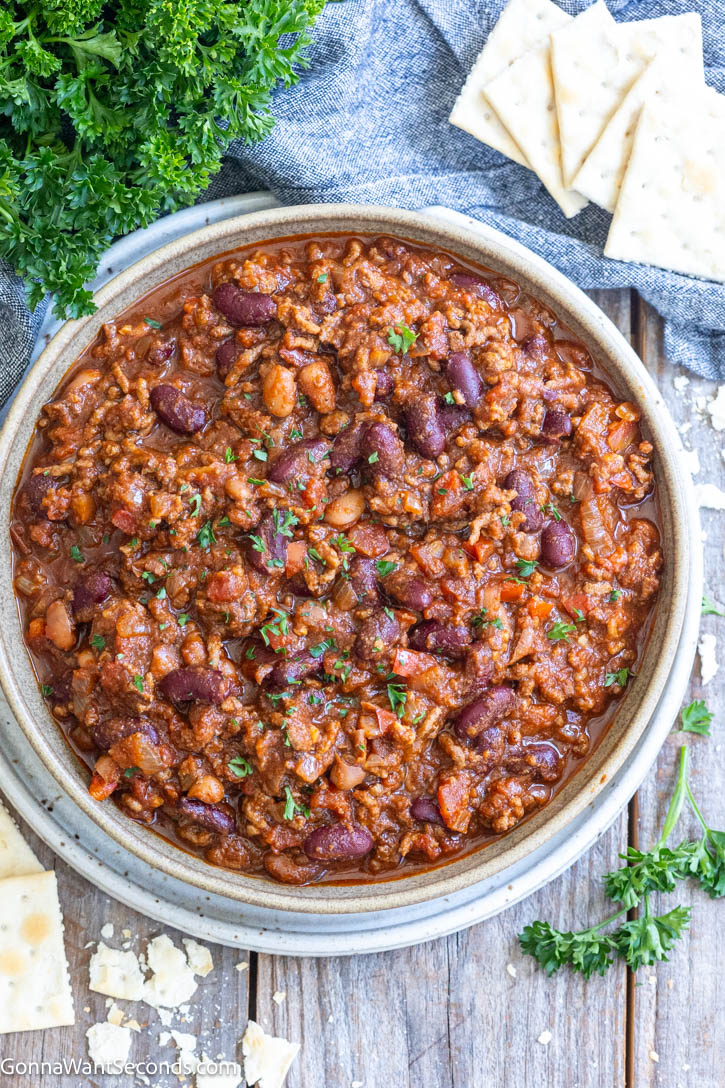 This easy Crockpot Chili is loaded with ground beef, beans, tomatoes, and classic spices, slow-cooked into a rich, thick, hearty family dinner. #crockpotchili #chili A bowl of crockpot chili top shot