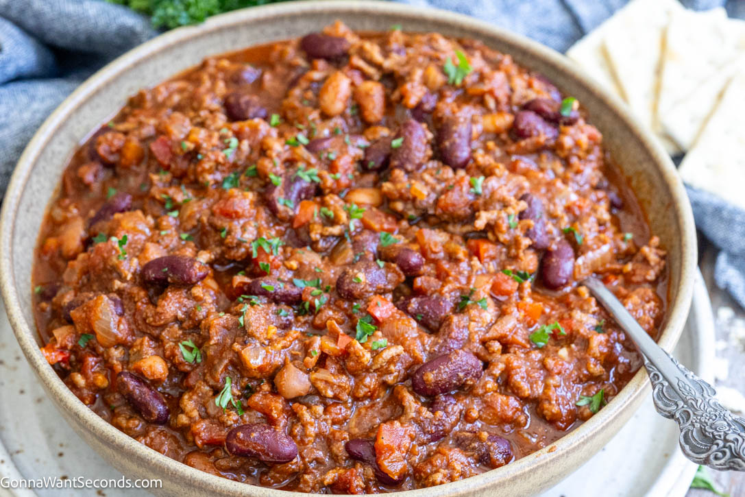 This easy Crockpot Chili is loaded with ground beef, beans, tomatoes, and classic spices, slow-cooked into a rich, thick, hearty family dinner. #crockpotchili #chili A bowl of crockpot chili