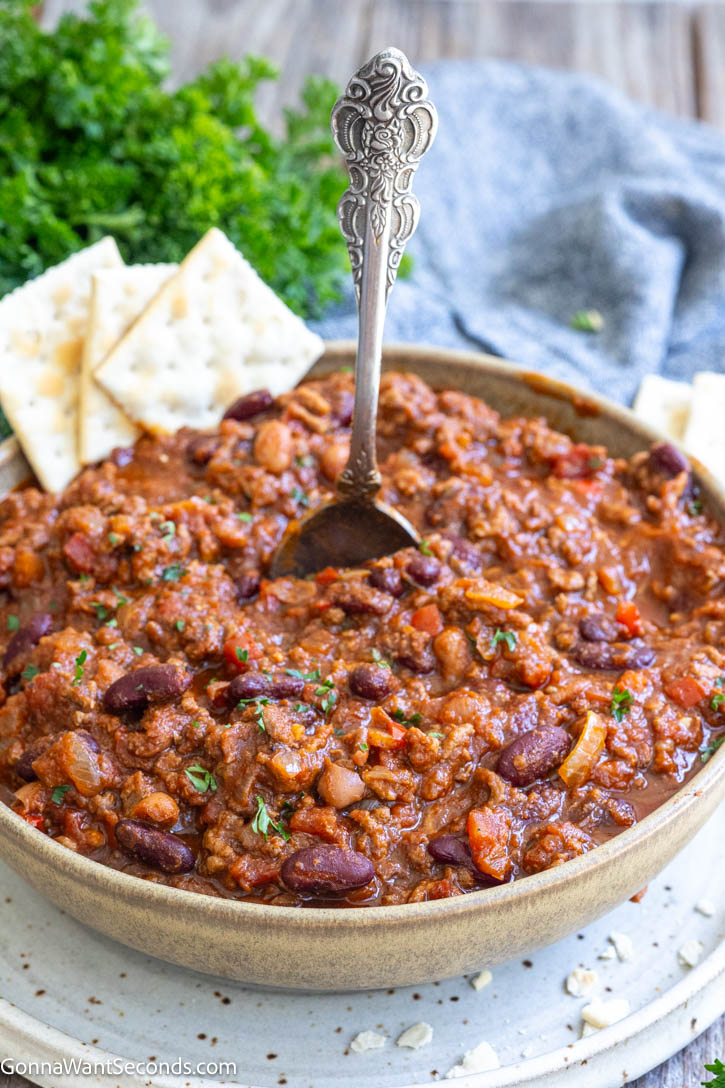 This easy Crockpot Chili is loaded with ground beef, beans, tomatoes, and classic spices, slow-cooked into a rich, thick, hearty family dinner. #crockpotchili #chili
A bowl of crockpot chili topped with crackers