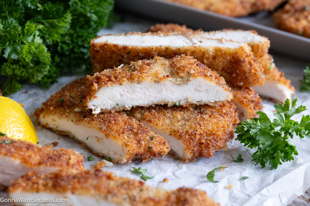 sliced homemade chicken cutlets with crispy seasoned coating