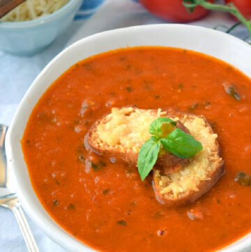 Ina Garten Tomato Soup with bread on top in a bowl
